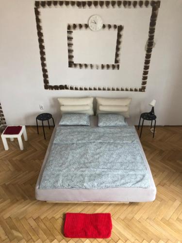 a bedroom with a bed with a clock on the wall at Pokój 11A in Krakow