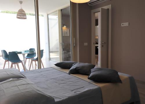 a bedroom with a bed with two pillows on it at Pescoluse Apartments in Marina di Pescoluse
