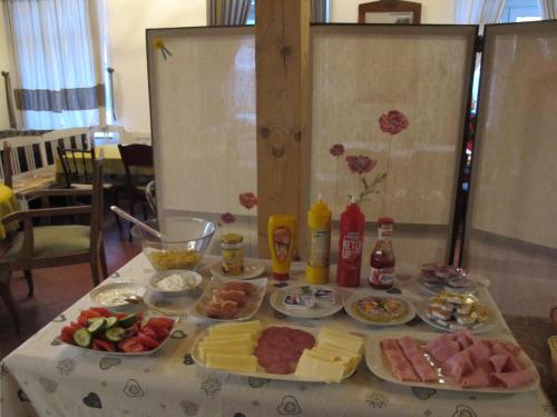 a table with plates of food on a table at Penzion SPORTINO in Svoboda nad Úpou