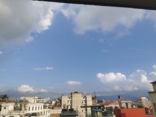 a view of a city with buildings and clouds at Om Bramha Hotel in Kathmandu