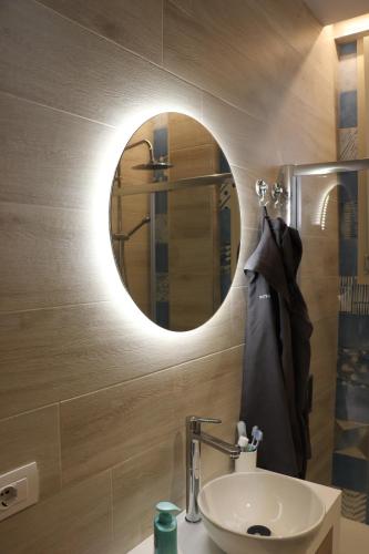 a bathroom with a sink and a mirror at Pescoluse Apartments in Marina di Pescoluse