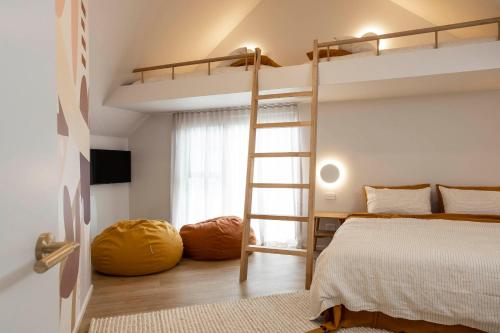 a bedroom with two bunk beds and a ladder at John and Jane's Beechworth in Beechworth