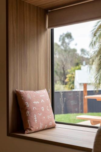 a pillow sitting on a window sill next to a window at John and Jane's Beechworth in Beechworth
