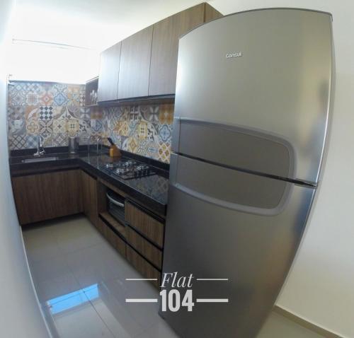 a stainless steel refrigerator in a kitchen at TH Flats com Banheira de Hidromassagem in Governador Valadares