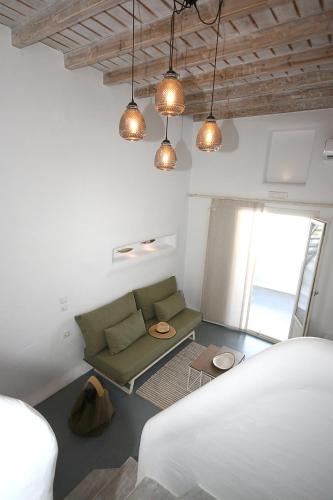 a living room with a couch and a table at 5 Traditional Suites in Livadi Astypalaias