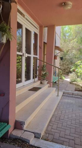 an entrance to a pink house with a window at On the Edge of a Crater in Mitzpe Ramon