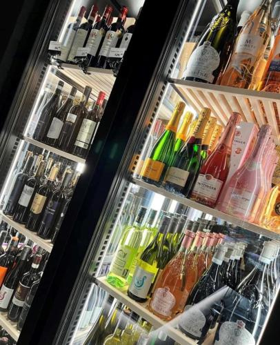 a refrigerator filled with lots of bottles of wine at Motel Inn Simbach in Simbach am Inn