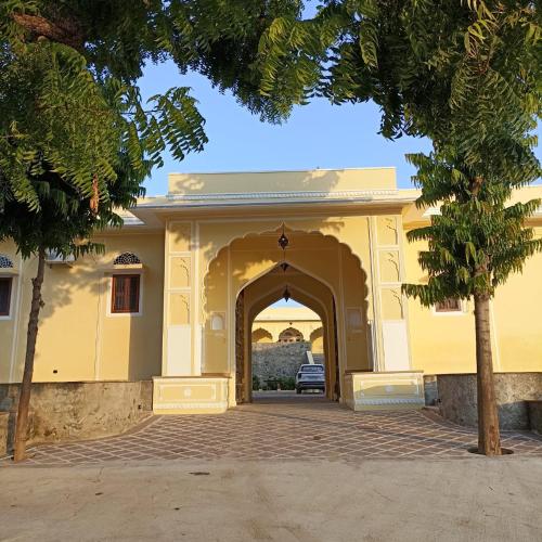 an entrance to a building with a tree in front at Fort Chabariya in Kekri