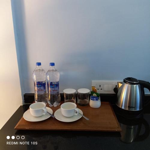 a table with two bottles of water and two cups at Fort Chabariya in Kekri