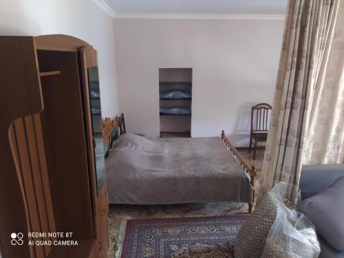 a bedroom with a bed next to a bed sqor at Apartment in Mtskheta, with beautiful nature, 100 meter from center in Mtskheta