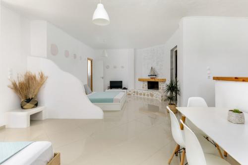 a white living room with white furniture and a fireplace at Newly Built All Season Resort in Néa Sílata