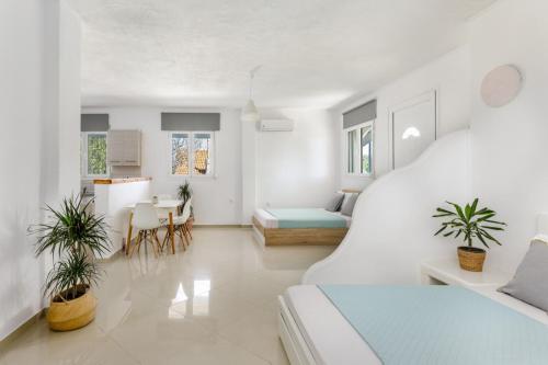 a white living room with a couch and a table at Newly Built All Season Resort in Néa Sílata