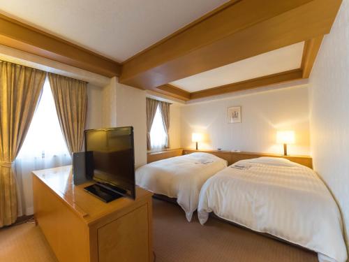 Postel nebo postele na pokoji v ubytování Hotel Matsunoka Ichinoseki
