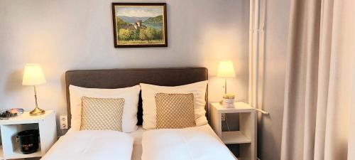 a bedroom with a bed with two night stands and two lamps at Schieszl Apartments 1 in Budapest