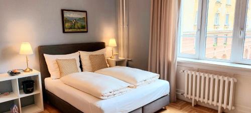ブダペストにあるSchieszl Apartments 1のベッドルーム1室(白いシーツ付きのベッド1台、窓付)