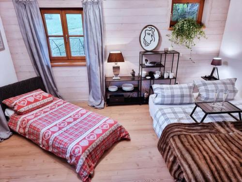 a living room with a bed and a couch at Fritzis Alpenidyll „Sommertraum & Winterromantik” in Samerberg