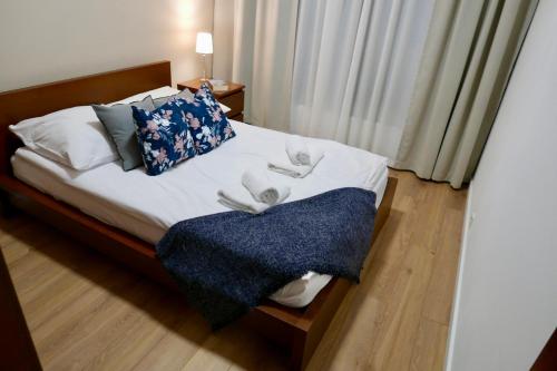 a bedroom with a bed with two towels on it at Zdrowa Apartment in Wilanów in Warsaw