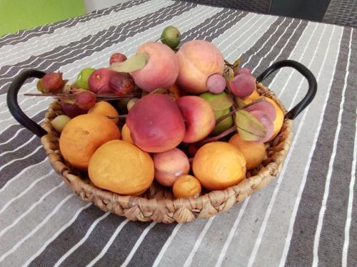 a basket of fruit sitting on a table at Oro&Mattia's House in Trapani