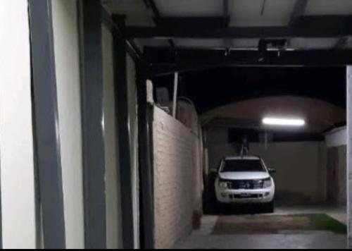 a car is parked in a parking garage at Alojamiento en Mendoza in Godoy Cruz