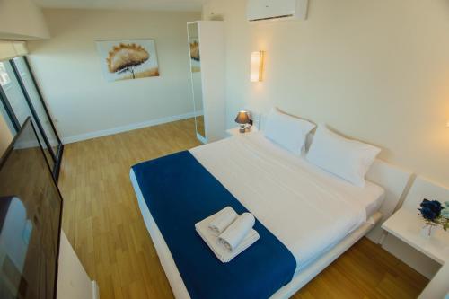 a bedroom with a bed with two towels on it at Batumi River Source in Batumi