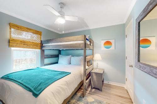 a bedroom with a bunk bed and a window at Sunset Breeze #4 in Dauphin Island