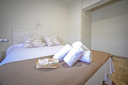 a bed with two pillows and a tray on it at Hotel Montemar in La Marina