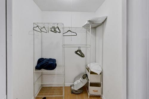 a room with a closet with hangers and shoes at Cinderella's Beach Cottage in North Palm Beach