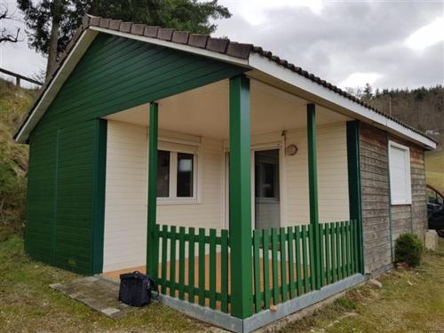 a small green and white house with a porch at Camping La Douce Ardèche in Désaignes
