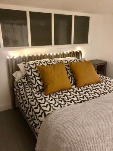 - un lit avec des oreillers en noir et blanc dans une chambre dans l'établissement Appartement FACE MER accès direct plage, à Houlgate