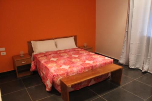 a small bedroom with a bed and a table at A & A TERANGA in Somone