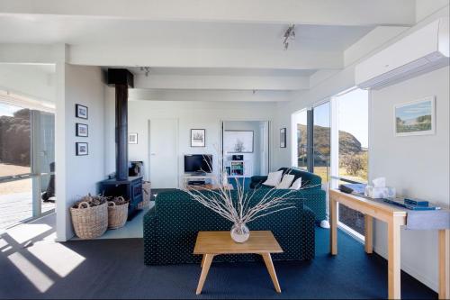a living room with a couch and a table at Moggs View in Aireys Inlet