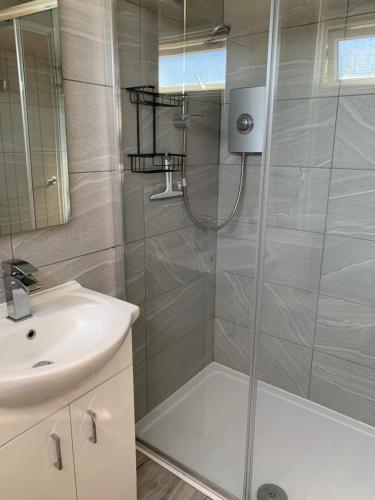 a bathroom with a shower and a sink at 265 Belle Aire, Modern Property in Hemsby