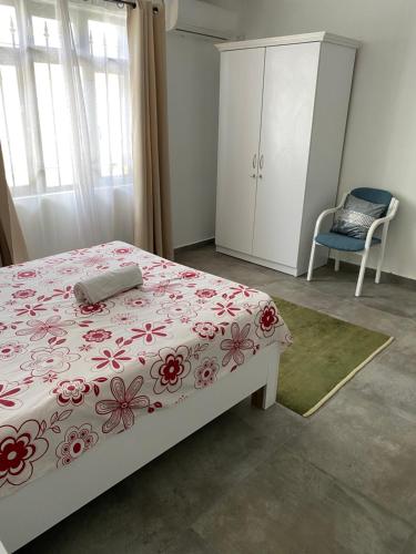 a bedroom with a bed and a cabinet and a chair at 2 Bedroom Apartment in Pereybere with Private Balcony in Pereybere