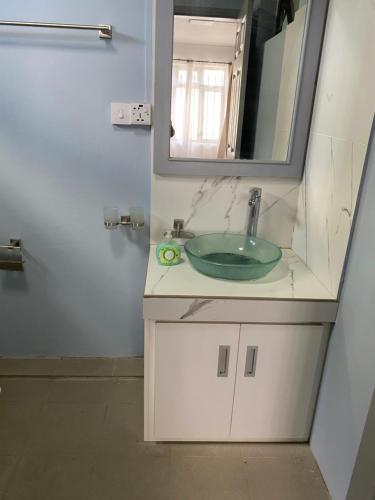 a bathroom with a sink and a mirror at 2 Bedroom Apartment in Pereybere with Private Balcony in Pereybere
