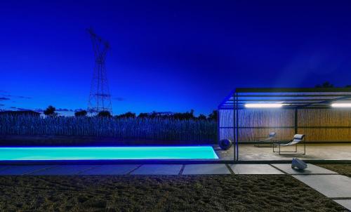a house with a swimming pool at night at Bouca Houses in Messini