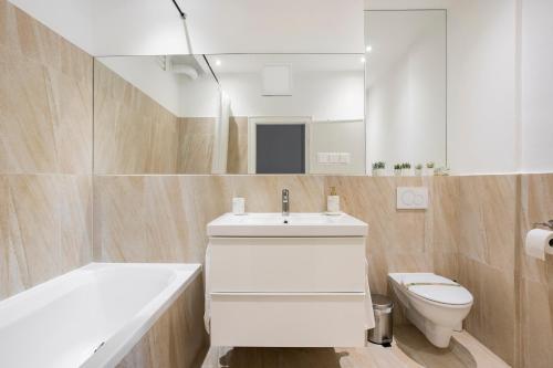 a bathroom with a white sink and a toilet at CITY CENTER- stylish & sunny Appartement in Vienna