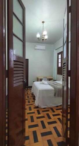 a bedroom with a bed and a room with a window at Casa 307 in Manaus