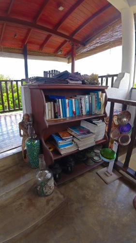 a book shelf filled with books on a porch at Fort Dew Guest House in Galle