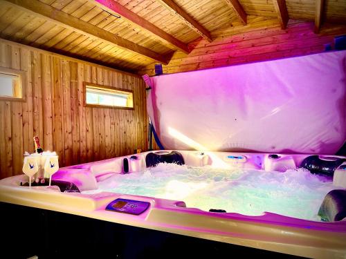 a hot tub in a room with chairs in it at Beautiful Hot Tub Suite in Lytham St Annes in Lytham St Annes