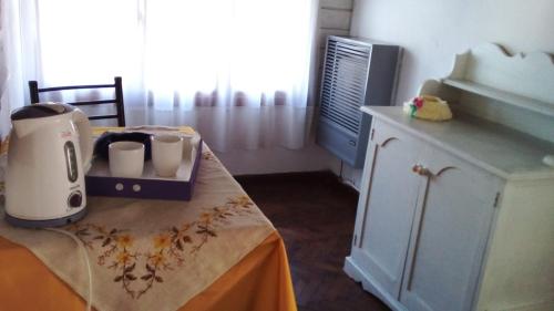 a kitchen with a table with a coffee maker on it at Victoria in Esquel