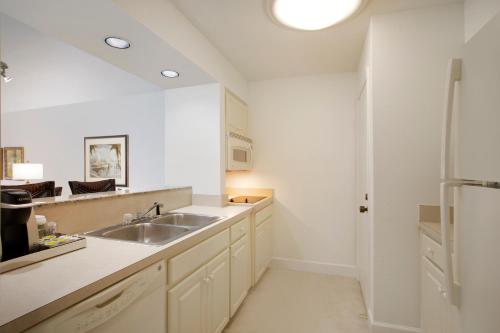 a white kitchen with a sink and a refrigerator at Saddlebrook Golf Resort & Spa Tampa North-Wesley Chapel in Wesley Chapel