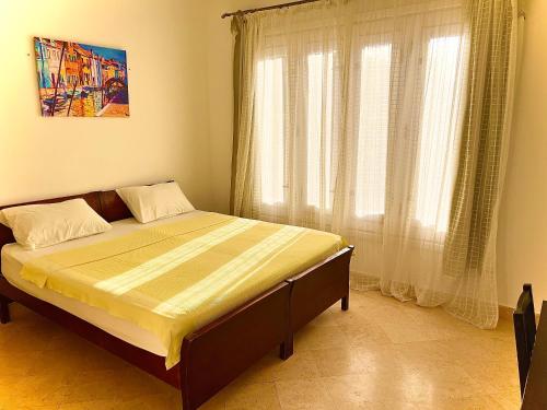 a bed in a bedroom with a large window at South marina apartment MS10 Wi-Fi available in Hurghada