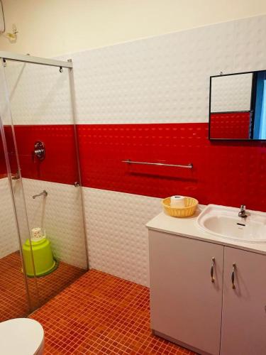 a bathroom with a shower and a sink and a toilet at Castle Villa in Ernakulam