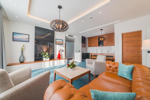 a living room with a couch and a table at Kalamper Hotel & Spa in Dobra Voda