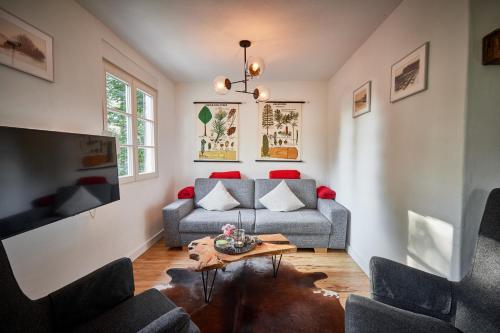 a living room with a couch and a table at Ferienhaus Asten-Lodge in Winterberg