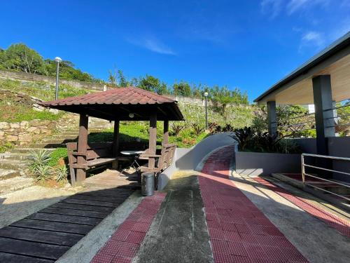 a pavilion with a picnic table and a bench at La View Mountain Resort in Damasanan