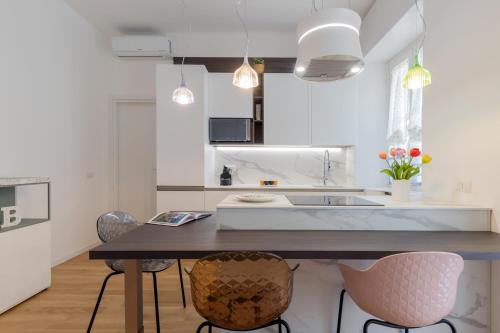 a kitchen with a table and chairs in a room at Design Premium Apartment in Center Milan - HomeUnity in Milan