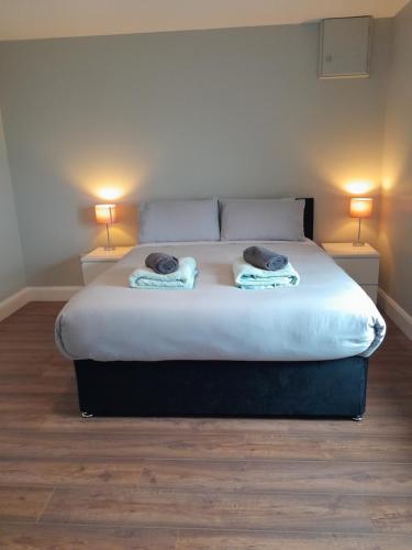 a bedroom with a large bed with two lamps at Hilltop Haven, Doolin in Doolin