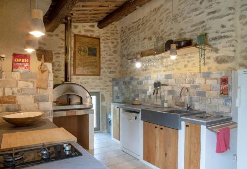 a kitchen with a sink and a counter top at Maison du bonheur 10pers Piscine Privee et Chauffee in Grignan