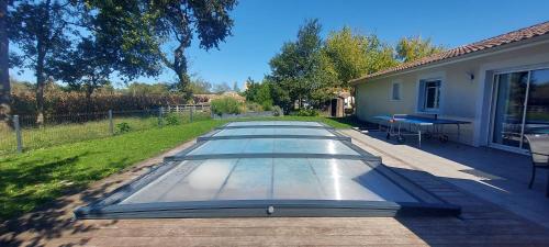 a row of glass tables on a patio at Maison familiale au calme avec piscine securisee in Le Barp